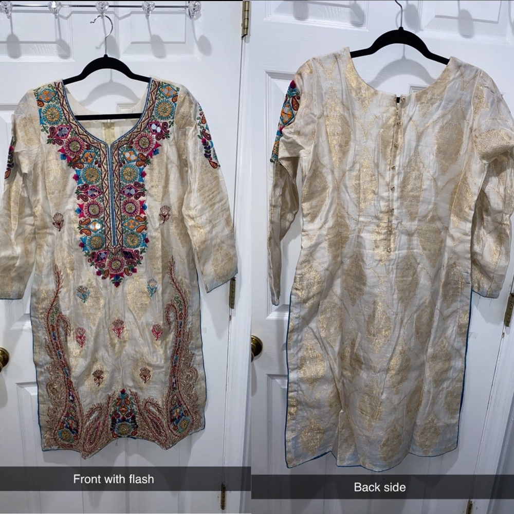 White dress with embroidered and mirror work.